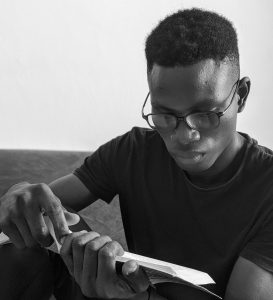nigerian-black-young-boy-reading-for-ielts-gmat-exam-without-parent